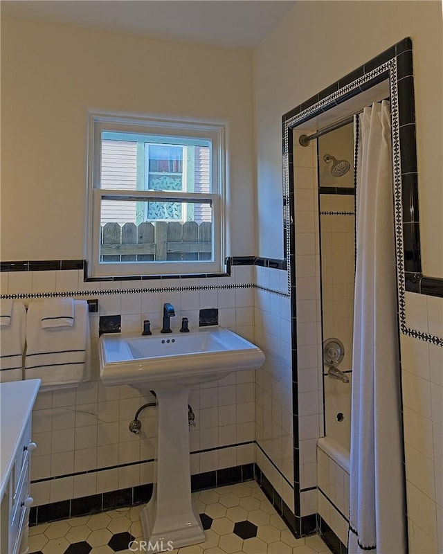 550 N 1st Ave, Upland, CA 91786 - full bath with tile walls, tile patterned floors, tiled shower / bath combo, and a wainscoted wall