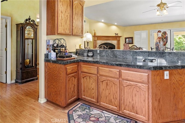1350 Cardo Way, Nipomo, CA 93444 - kitchen featuring a ceiling fan, light wood-style flooring, a peninsula, dark countertops, and brown cabinetry