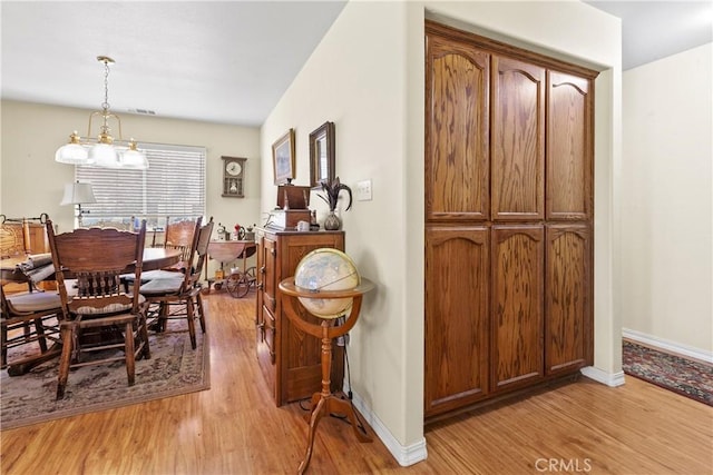 1350 Cardo Way, Nipomo, CA 93444 - dining area with light wood-type flooring, baseboards, and a chandelier