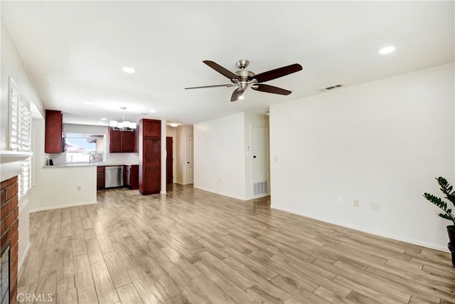 27057 Rangewood St, Menifee, CA 92586 - unfurnished living room featuring a fireplace, a chandelier, ceiling fan, light wood finished floors, and recessed lighting