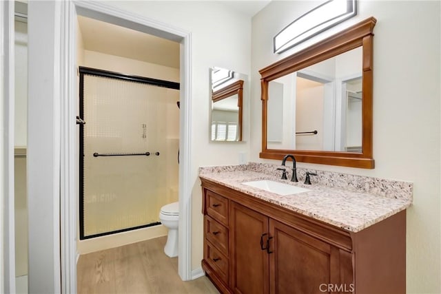 27057 Rangewood St, Menifee, CA 92586 - bathroom featuring a stall shower, wood finished floors, toilet, and vanity