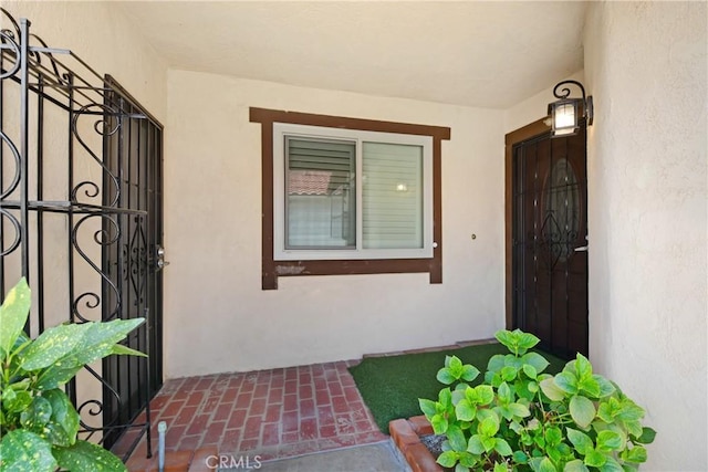 27057 Rangewood St, Menifee, CA 92586 - doorway to property with stucco siding