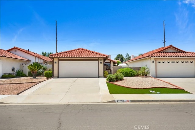 27057 Rangewood St, Menifee, CA 92586 - mediterranean / spanish-style home featuring a tile roof, concrete driveway, an attached garage, and stucco siding