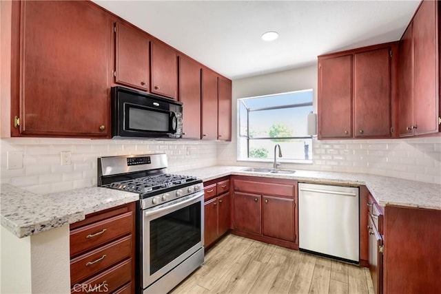 27057 Rangewood St, Menifee, CA 92586 - kitchen with stainless steel appliances, a sink, light wood-style flooring, decorative backsplash, and recessed lighting