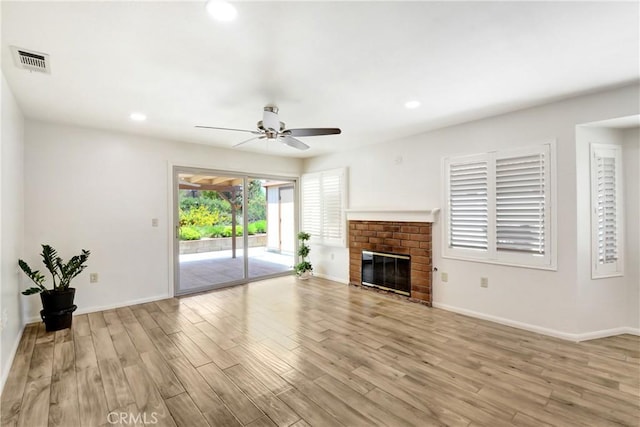 27057 Rangewood St, Menifee, CA 92586 - unfurnished living room with light wood-type flooring, a ceiling fan, baseboards, recessed lighting, and a brick fireplace