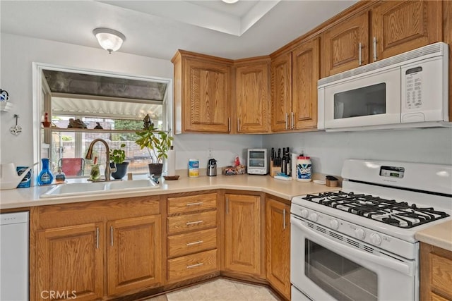 757 Yuma Ct, San Dimas, CA 91773 - kitchen with white appliances, a sink, light countertops, and brown cabinetry