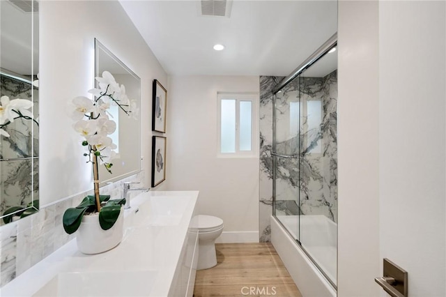 2817 San Ramon Dr, Rancho Palos Verdes, CA 90275 - full bath with toilet, double vanity, wood finished floors, recessed lighting, and combined bath / shower with glass door