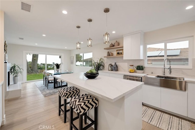 2817 San Ramon Dr, Rancho Palos Verdes, CA 90275 - kitchen featuring a sink, a kitchen breakfast bar, open shelves, white cabinetry, and recessed lighting
