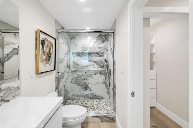 2817 San Ramon Dr, Rancho Palos Verdes, CA 90275 - bathroom with toilet, a marble finish shower, vanity, wood finished floors, and recessed lighting