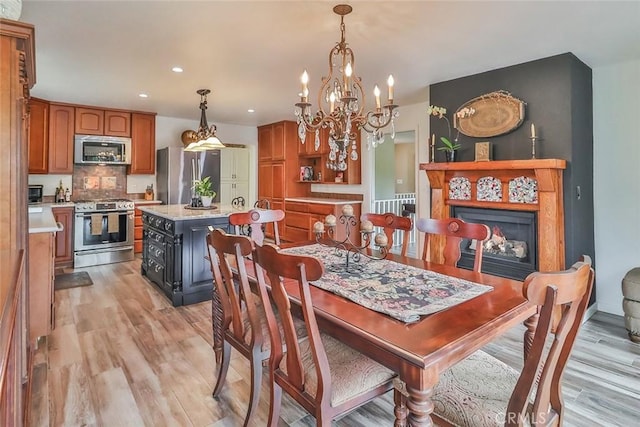 240 Portal St, Oak View, CA 93022 - dining space featuring light wood-style floors, recessed lighting, and a chandelier