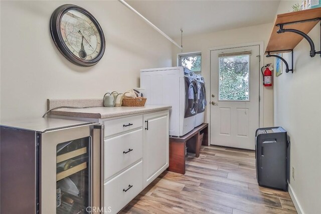 240 Portal St, Oak View, CA 93022 - laundry room featuring beverage cooler, independent washer and dryer, cabinet space, and light wood-style floors