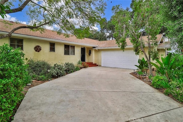 240 Portal St, Oak View, CA 93022 - view of front facade featuring stucco siding, an attached garage, and driveway