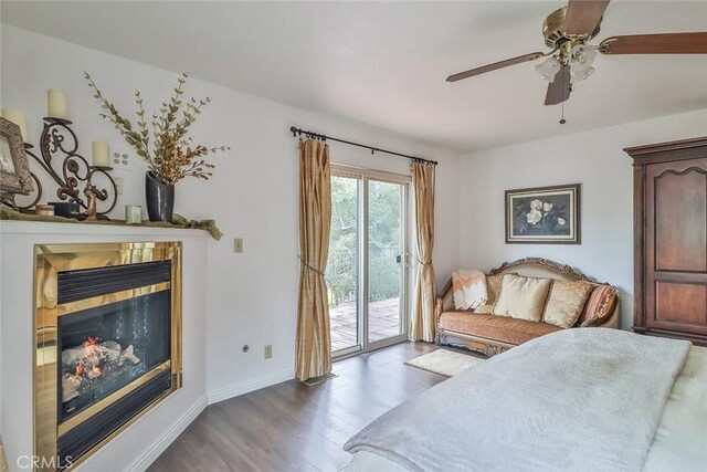 240 Portal St, Oak View, CA 93022 - bedroom with access to outside, a glass covered fireplace, wood finished floors, baseboards, and ceiling fan
