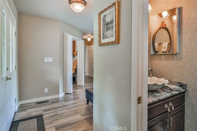 240 Portal St, Oak View, CA 93022 - corridor featuring light wood-style floors, a sink, and baseboards