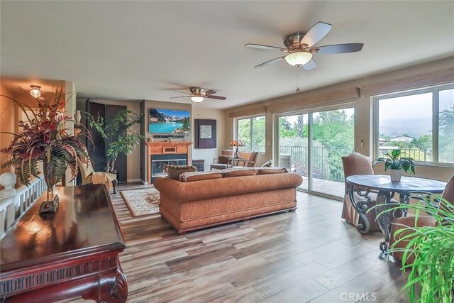240 Portal St, Oak View, CA 93022 - living room featuring a ceiling fan, a fireplace, and wood finished floors