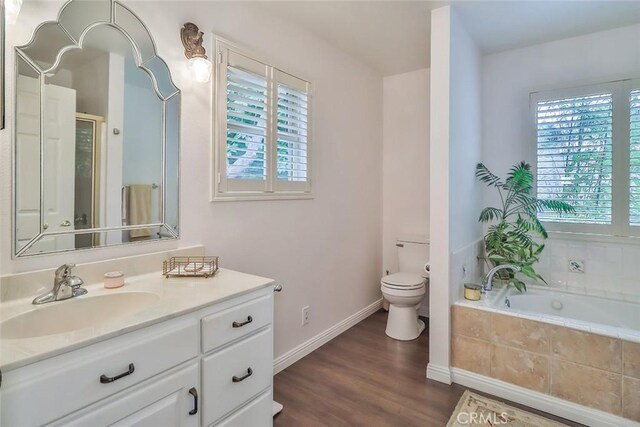 240 Portal St, Oak View, CA 93022 - bathroom featuring vanity, a garden tub, wood finished floors, toilet, and baseboards