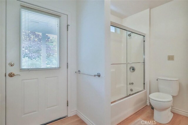 240 Portal St, Oak View, CA 93022 - bathroom with wood finished floors, toilet, enclosed tub / shower combo, and baseboards