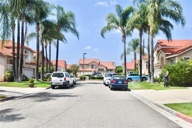 1550 Balsam Dr, Pomona, CA 91766 - view of asphalt street with curbs, a residential view, and sidewalks