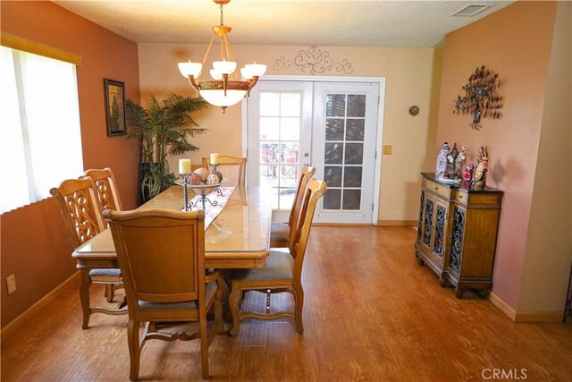 5685 Ptolemy Way, Jurupa Valley, CA 91752 - dining space featuring a chandelier, wood finished floors, and baseboards