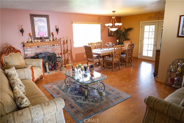 5685 Ptolemy Way, Jurupa Valley, CA 91752 - living area featuring a chandelier, wood finished floors, baseboards, and a fireplace