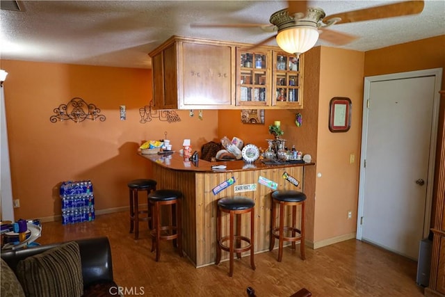 5685 Ptolemy Way, Jurupa Valley, CA 91752 - indoor bar with wood finished floors, ceiling fan, a textured ceiling, and baseboards