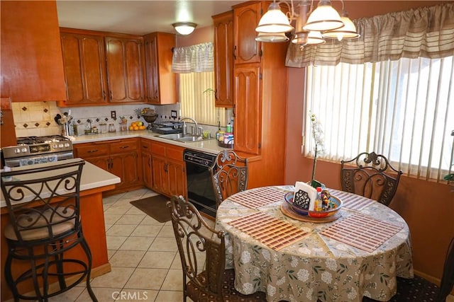 5685 Ptolemy Way, Jurupa Valley, CA 91752 - kitchen featuring black dishwasher, a sink, light countertops, and healthy amount of natural light