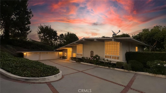 12 Pinto Ln, Rolling Hills Estates, CA 90274 - property exterior at dusk featuring stucco siding and driveway
