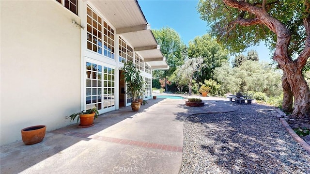12 Pinto Ln, Rolling Hills Estates, CA 90274 - view of patio / terrace featuring an outdoor pool and french doors