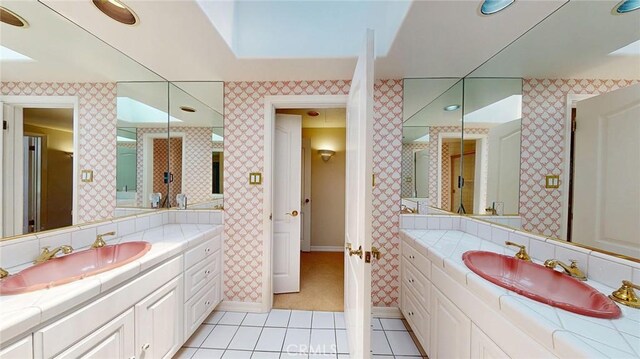 12 Pinto Ln, Rolling Hills Estates, CA 90274 - bathroom featuring wallpapered walls, tile patterned floors, and two vanities