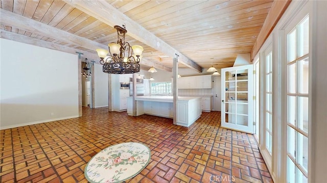 12 Pinto Ln, Rolling Hills Estates, CA 90274 - kitchen featuring a wooden ceiling with exposed beams, a chandelier, white cabinets, brick floors, and light countertops
