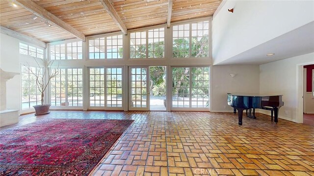 12 Pinto Ln, Rolling Hills Estates, CA 90274 - living area with healthy amount of natural light, a wood ceiling with exposed beams, a high ceiling, track lighting, and brick floors
