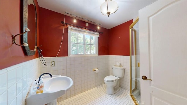 12 Pinto Ln, Rolling Hills Estates, CA 90274 - full bathroom featuring tile walls, a stall shower, tile patterned floors, and wainscoting