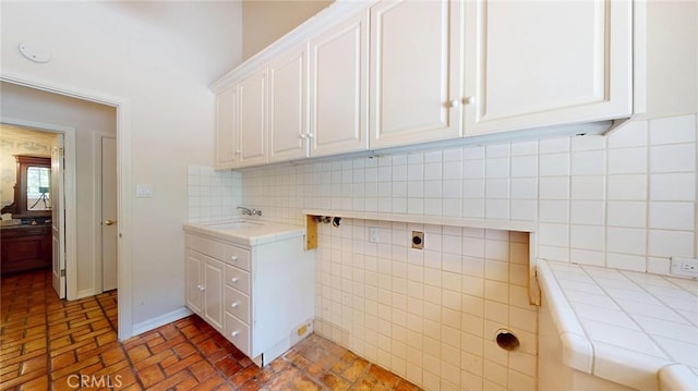 12 Pinto Ln, Rolling Hills Estates, CA 90274 - laundry room featuring cabinet space, brick patterned floors, and electric dryer hookup