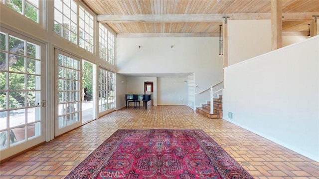 12 Pinto Ln, Rolling Hills Estates, CA 90274 - unfurnished living room with brick floors, a wooden ceiling with exposed beams, stairs, a high ceiling, and plenty of natural light