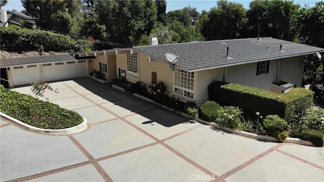 12 Pinto Ln, Rolling Hills Estates, CA 90274 - view of front of house featuring stucco siding, driveway, and an attached garage