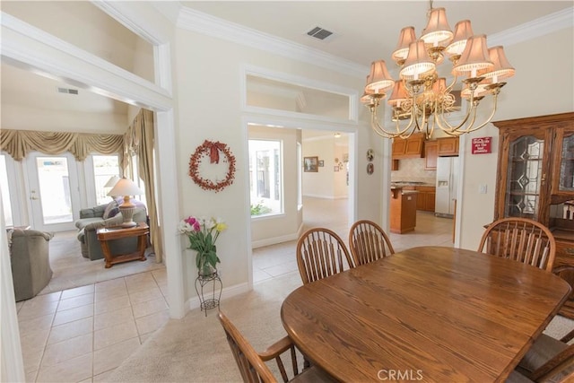 337 W Trenton Ave, Clovis, CA 93619 - dining room with light tile patterned floors, light carpet, crown molding, and a chandelier