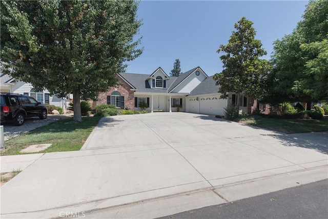 337 W Trenton Ave, Clovis, CA 93619 - view of front facade with an attached garage, driveway, and brick siding