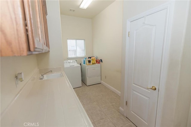 337 W Trenton Ave, Clovis, CA 93619 - laundry area featuring independent washer and dryer, light tile patterned flooring, and cabinet space