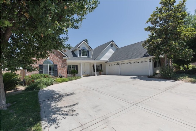 337 W Trenton Ave, Clovis, CA 93619 - traditional-style house featuring an attached garage, brick siding, and concrete driveway