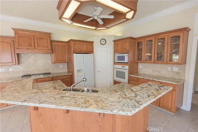 337 W Trenton Ave, Clovis, CA 93619 - kitchen featuring white appliances, brown cabinetry, light tile patterned floors, crown molding, and glass insert cabinets