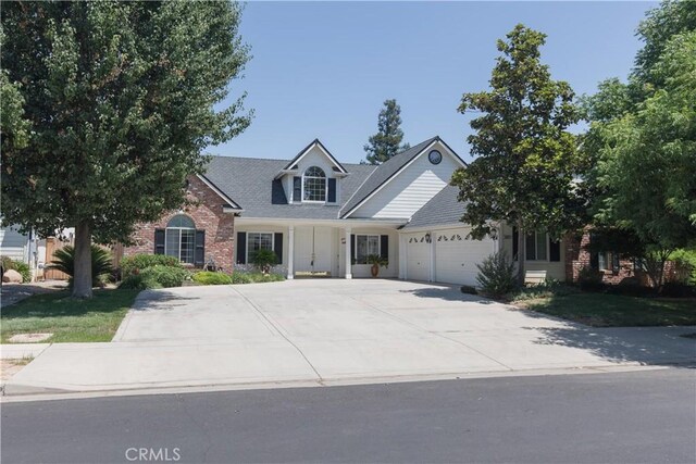337 W Trenton Ave, Clovis, CA 93619 - view of front facade with a garage, brick siding, and concrete driveway