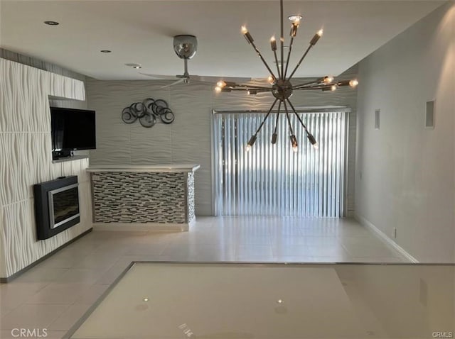 1553 Spyglass, Palm Springs, CA 92264 - unfurnished dining area featuring a chandelier, light tile patterned flooring, a fireplace, and baseboards