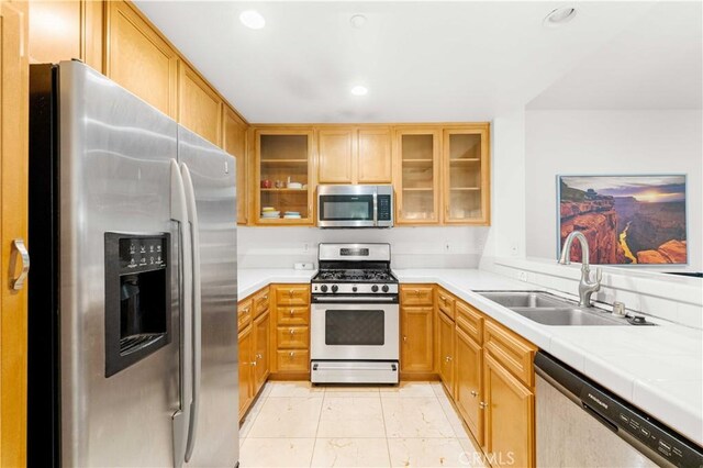 32 Perennial, Irvine, CA 92603 - kitchen with stainless steel appliances, recessed lighting, and glass insert cabinets