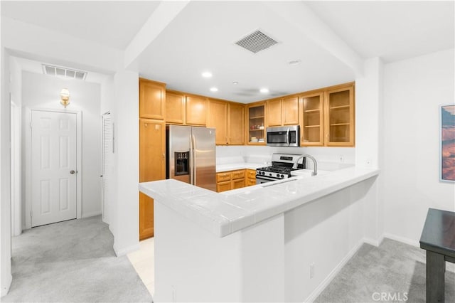 32 Perennial, Irvine, CA 92603 - kitchen with stainless steel appliances, light colored carpet, glass insert cabinets, a peninsula, and recessed lighting