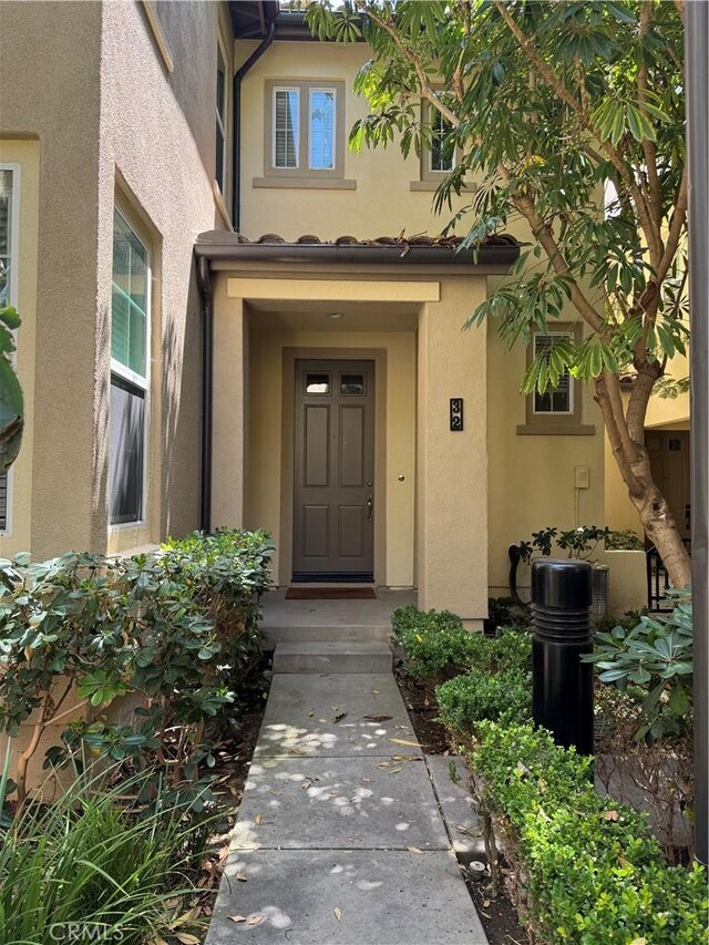 32 Perennial, Irvine, CA 92603 - doorway to property featuring stucco siding