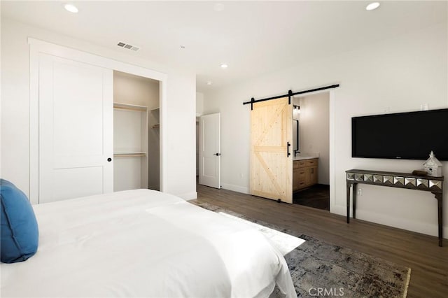 1773 Drendel Cir, Paradise, CA 95969 - bedroom featuring a barn door, wood finished floors, baseboards, recessed lighting, and ensuite bath