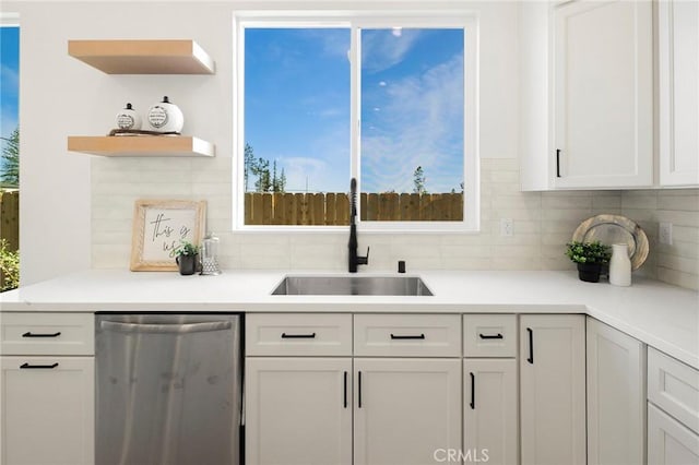 1773 Drendel Cir, Paradise, CA 95969 - kitchen featuring stainless steel dishwasher, a sink, backsplash, and white cabinetry