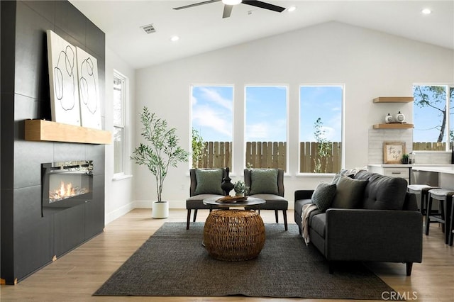 1773 Drendel Cir, Paradise, CA 95969 - living room with ceiling fan, a tile fireplace, lofted ceiling, light wood-type flooring, and recessed lighting