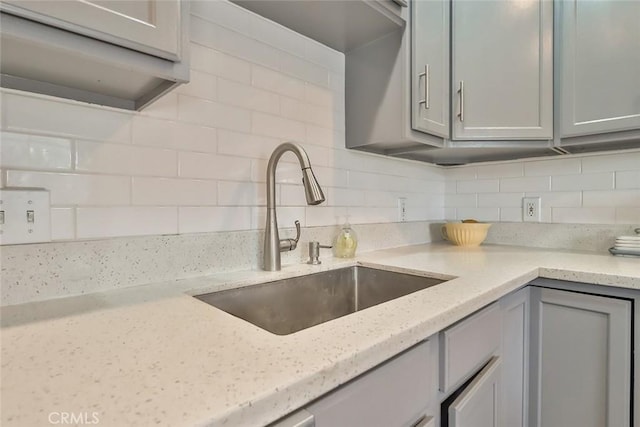 2025 N Buena Vista St, Burbank, CA 91504 - kitchen featuring a sink, backsplash, gray cabinetry, and light stone countertops