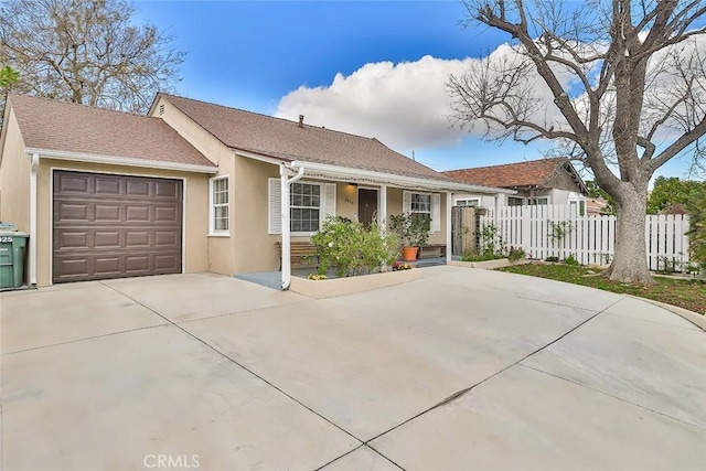 2025 N Buena Vista St, Burbank, CA 91504 - ranch-style home featuring an attached garage, stucco siding, driveway, and covered porch